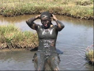 Sexy Girl playing in the River Mud. Muddy fun (Fully Clothed)